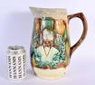 AN UNUSUAL LARGE 19TH CENTURY MAJOLICA POTTERY JUG depicting figures in relief. 26 cm x 17 cm.