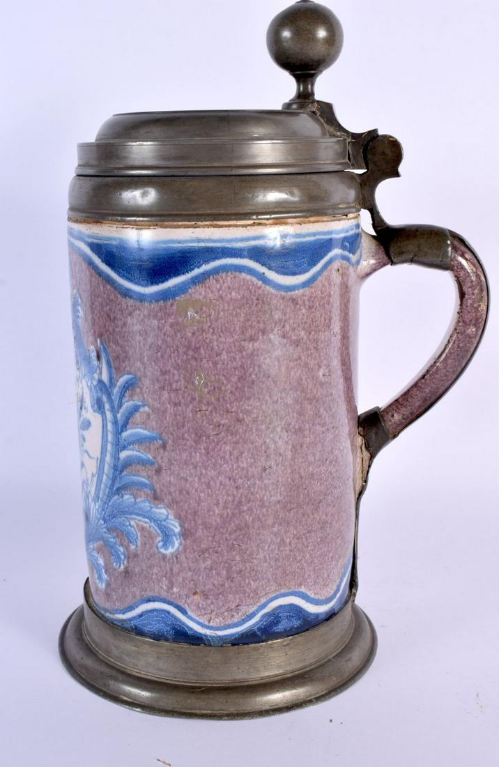 A LARGE 18TH CENTURY GERMAN MANGANESE GROUND FAIENCE STEIN painted with an armorial type panel. 27 c (1 of 5)