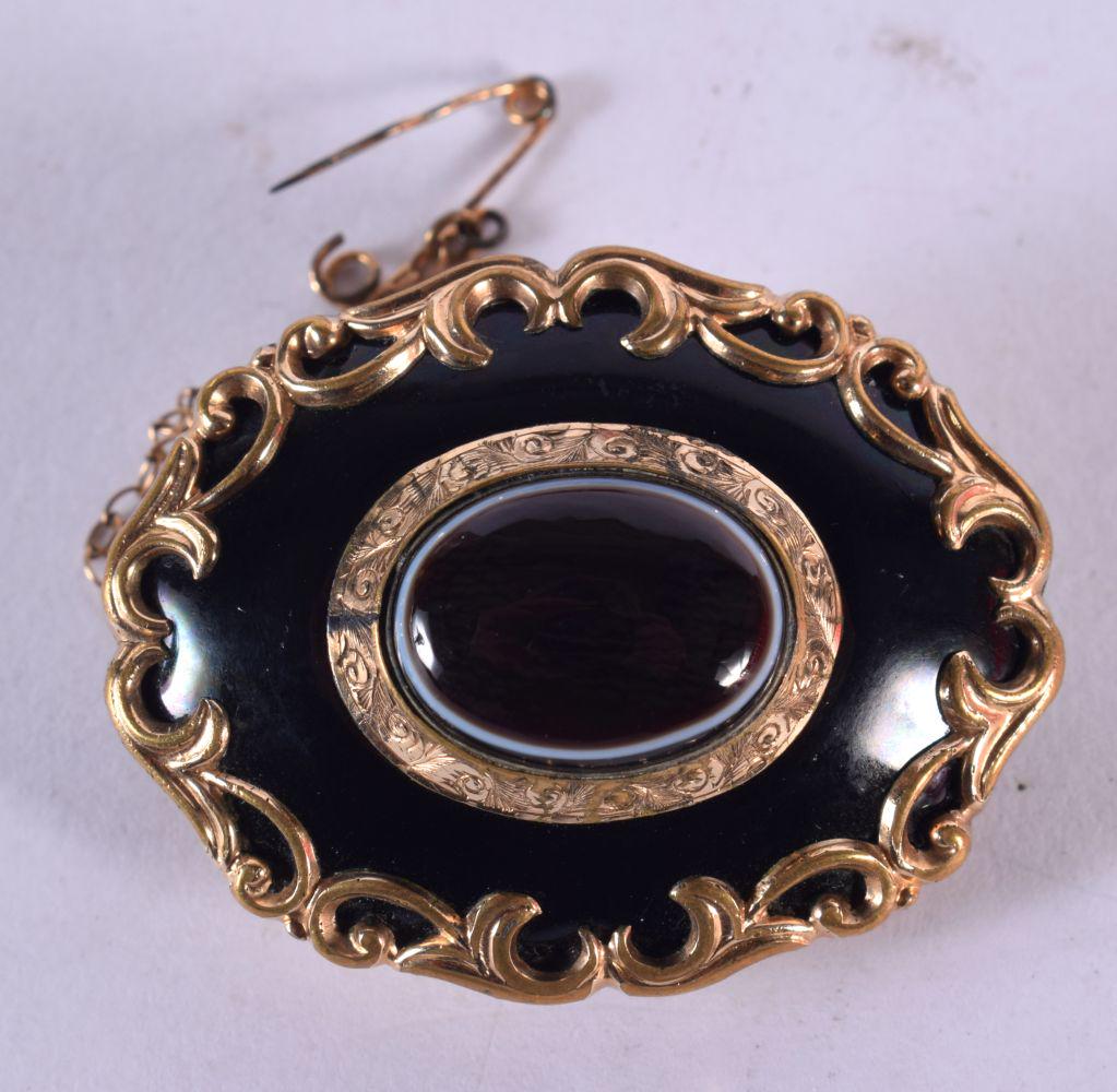 AN EARLY VICTORIAN YELLOW METAL AND ENAMEL MOURNING BROOCH. 16.8 grams. 4 cm x 3 cm. (1 of 3)