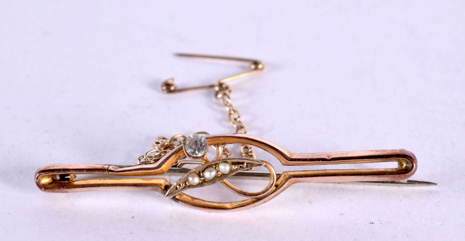 A 9CT GOLD AND DIAMOND BROOCH. 1.6 grams. 4.25 cm x 1 cm. (1 of 3)