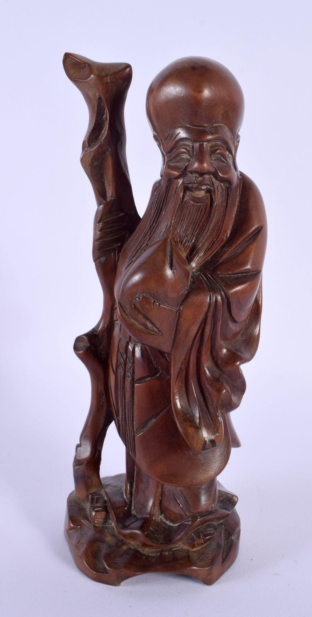 A 19TH CENTURY CHINESE CARVED HARDWOOD FIGURE OF SAGE modelled holding a peach. 19 cm high. (1 of 3)
