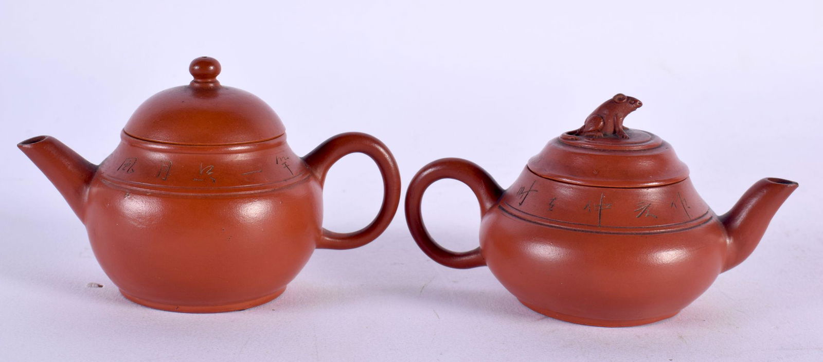 TWO LATE 19TH CENTURY CHINESE YIXING POTTERY TEAPOTS AND COVERS Qing. Largest 9.5 cm wide. (2) (1 of 4)