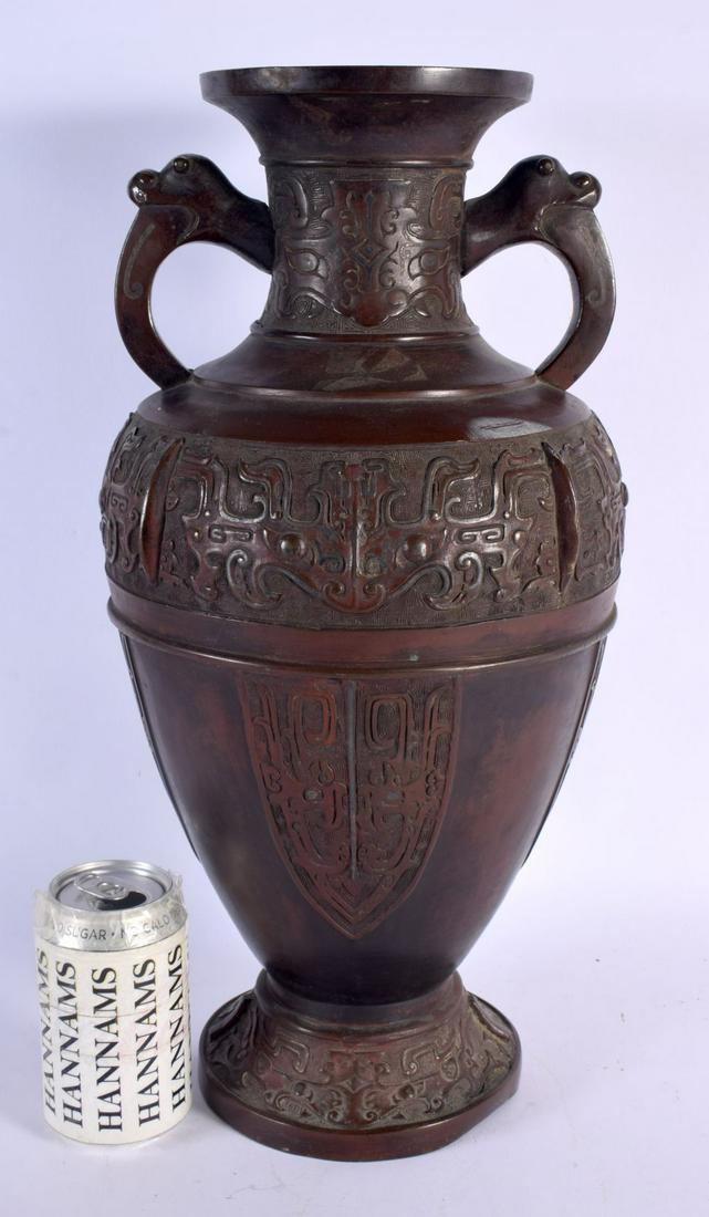 A VERY LARGE 19TH CENTURY JAPANESE MEIJI PERIOD TWIN HANDLED BRONZE VASE decorated with archaic mask (1 of 4)