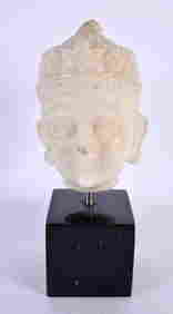 A 17TH/18TH CENTURY INDIAN CARVED MARBLE BUST modelled as a male wearing a floral embellished crown. (1 of 4)