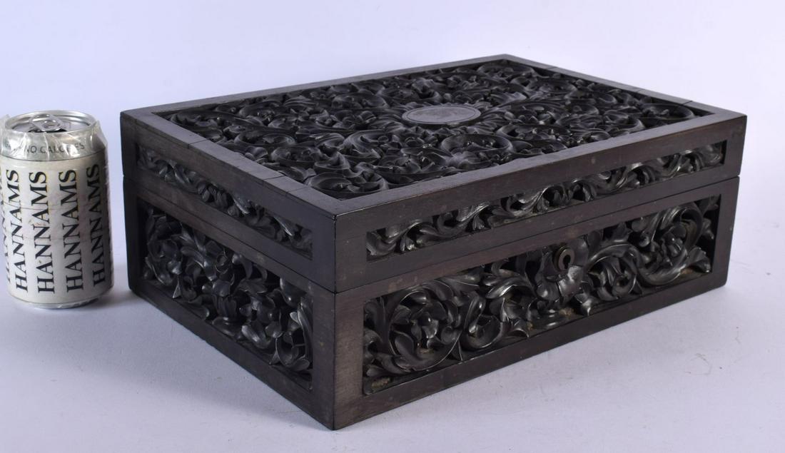 A LARGE EARLY 19TH CENTURY ANGLO INDIAN CARVED HARDWOOD CASKET decorated all over with foliage and v (1 of 4)