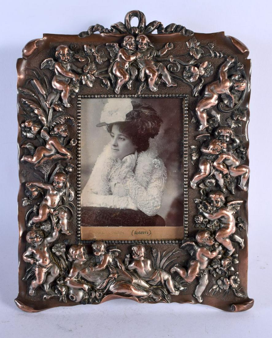 AN ANTIQUE ELECTRO PLATED MIXED METAL MIRROR decorated with putti. 30 cm x 24 cm.: AN ANTIQUE ELECTRO PLATED MIXED METAL MIRROR decorated with putti. 30 cm x 24 cm.