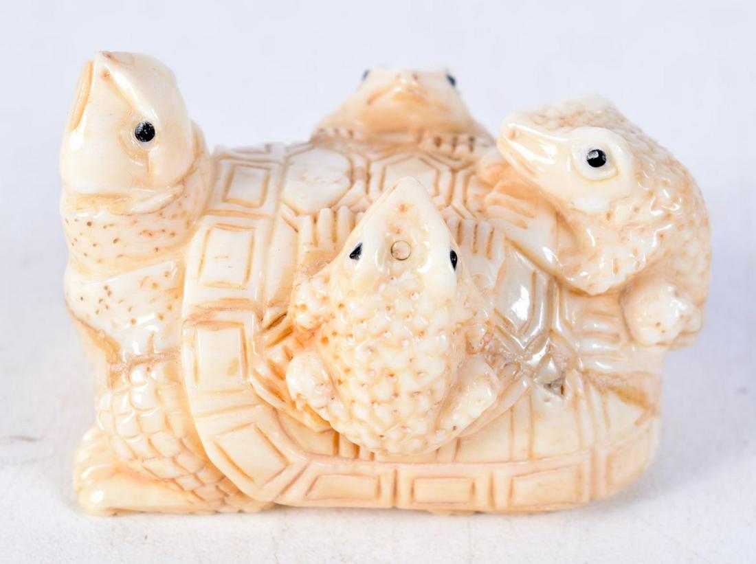 A JAPANESE BONE NETSUKE CARVED AS THREE FROGS ON A TURTLES BACK. 3.5cm x 5.2cm x 3.6cm: A JAPANESE BONE NETSUKE CARVED AS THREE FROGS ON A TURTLES BACK. 3.5cm x 5.2cm x 3.6cm