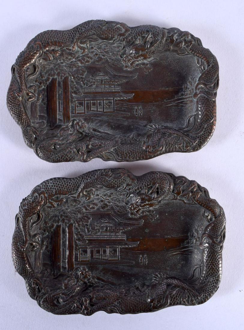 A PAIR OF 19TH CENTURY JAPANESE MEIJI PERIOD MIXED METAL DRAGON DISHES depicting landscapes. 14 cm x: A PAIR OF 19TH CENTURY JAPANESE MEIJI PERIOD MIXED METAL DRAGON DISHES depicting landscapes. 14 cm x 9 cm.