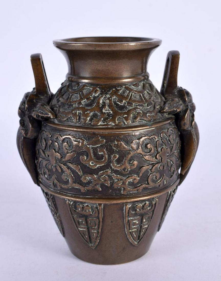A 19TH CENTURY JAPANESE MEIJI PERIOD TWIN HANDLED BRONZE VASE. 10 cm high.: A 19TH CENTURY JAPANESE MEIJI PERIOD TWIN HANDLED BRONZE VASE. 10 cm high.