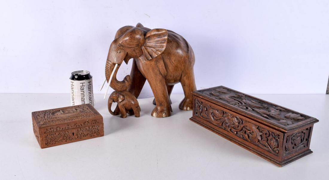 A large carved wooden elephant group, together with two carved boxes. Elephant 27 cm x 29 cm. (3) (1 of 6)