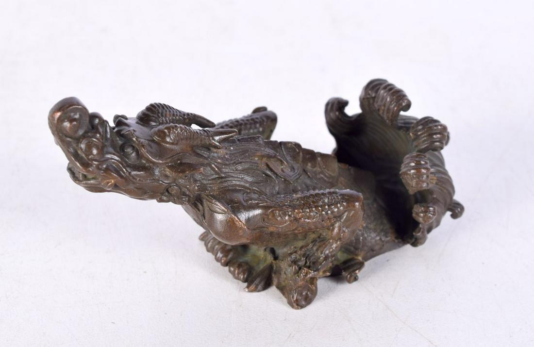A Chinese bronze scroll weight in the form of a dragon. 9 cm wide. (1 of 4)