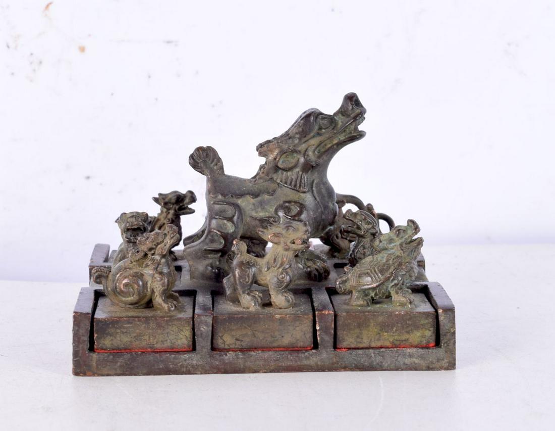 A large Chinese bronze seal, formed with eight removable mythical beast seals. 9.5 cm x 8.5 cm. (1 of 4)