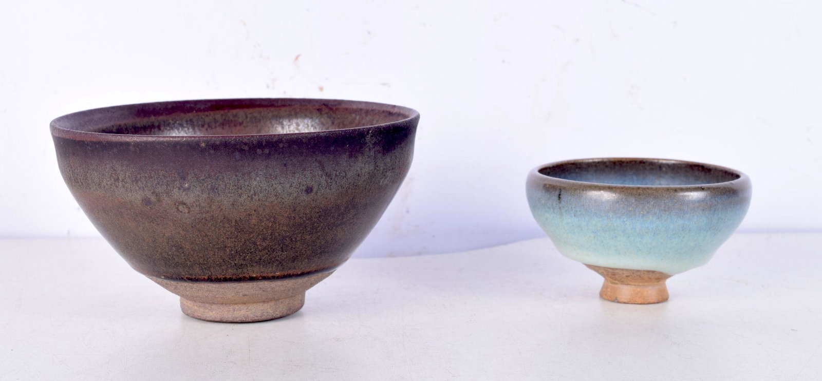 A Chinese hares foot pottery bowl, together with a junyao glazed bowl. Hares foot 12.5 cm wide. (2): A Chinese hares foot pottery bowl, together with a junyao glazed bowl. Hares foot 12.5 cm wide. (2)