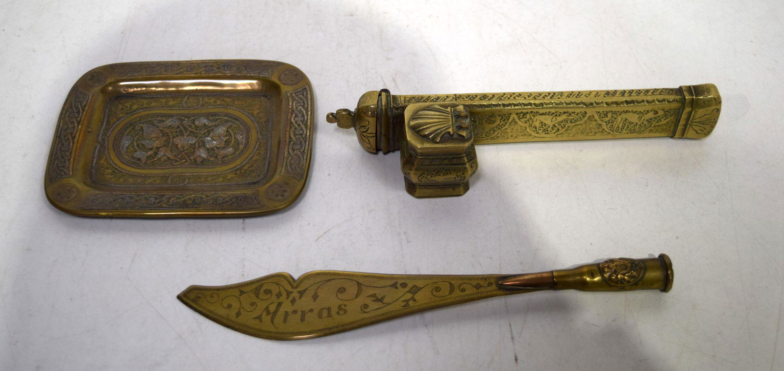 An embossed Islamic brass inkwell together with a small Islamic tray and a letter opener. Largest 21 (1 of 2)