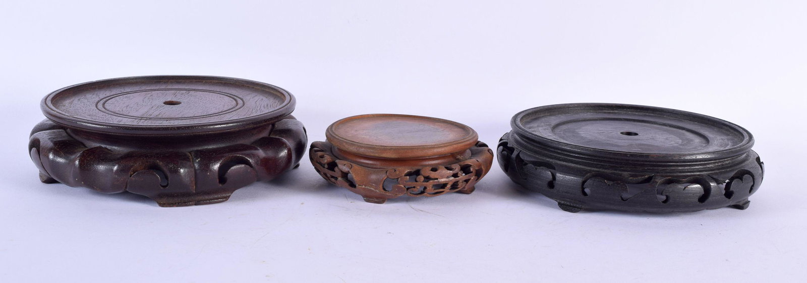 THREE EARLY 20TH CENTURY CHINESE CARVED WOOD STANDS Late Qing/Republic. Largest 17 cm wide. (3): THREE EARLY 20TH CENTURY CHINESE CARVED WOOD STANDS Late Qing/Republic. Largest 17 cm wide. (3)