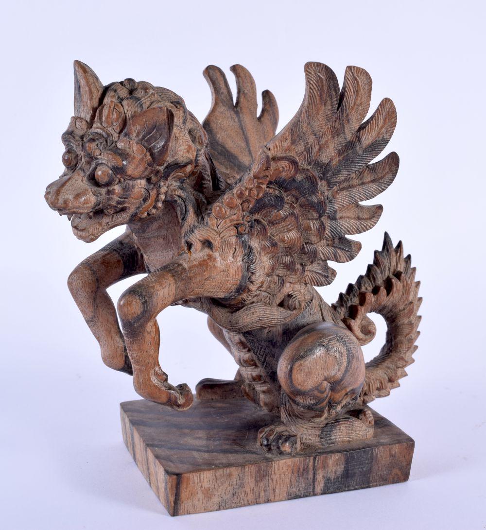 AN UNUSUAL SOUTH EAST ASIAN CARVED COROMANDEL FIGURE OF A BEAST modelled upon a square base. 18 cm x: AN UNUSUAL SOUTH EAST ASIAN CARVED COROMANDEL FIGURE OF A BEAST modelled upon a square base. 18 cm x 9 cm.