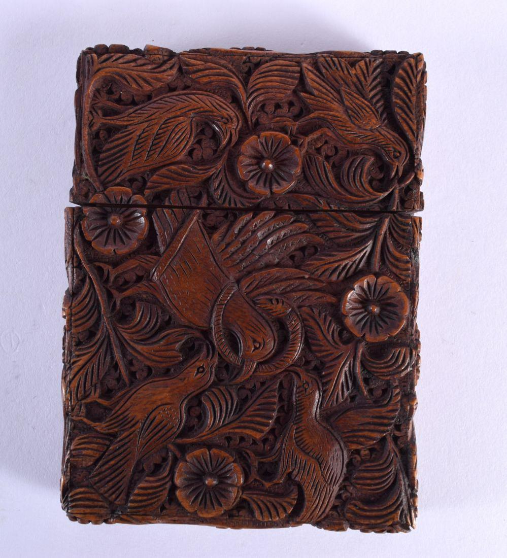 A 19TH CENTURY ANGLO INDIAN CARVED SANDALWOOD CARD CASE AND COVER decorated with birds amongst folia (1 of 6)