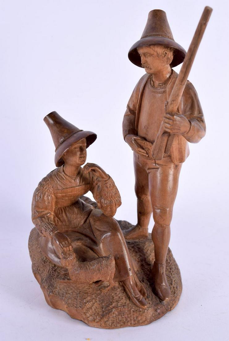 A LOVELY EARLY 20TH CENTURY SWISS BAVARIAN BLACK FOREST HUNTING GROUP modelled as a male and female (1 of 4)