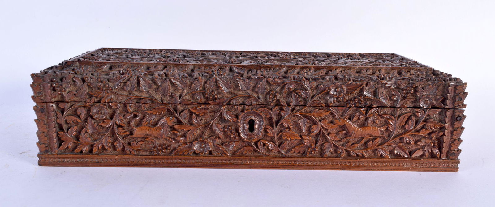 A LARGE 19TH CENTURY ANGLO INDIAN CARVED SANDALWOOD COUNTRY HOUSE CASKET depicting numerous animals (1 of 5)