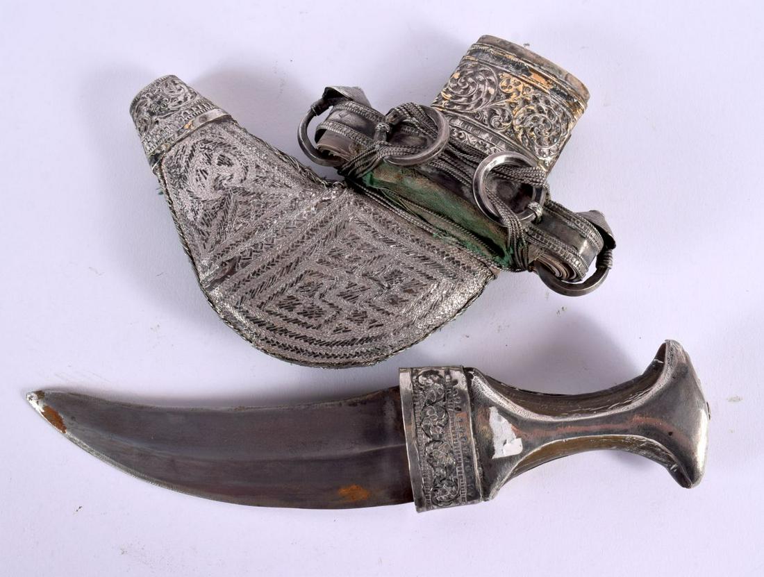 A 19TH CENTURY MIDDLE EASTERN OMANI SILVER MOUNTED RHINOCEROS HORN JAMBIYA DAGGER with elaborate rep (1 of 3)