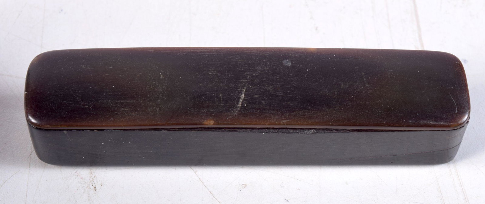 AN ANTIQUE CHINESE CARVED RHINOCEROS HORN SEAL BOX. 10 cm x 2 cm.: AN ANTIQUE CHINESE CARVED RHINOCEROS HORN SEAL BOX. 10 cm x 2 cm.