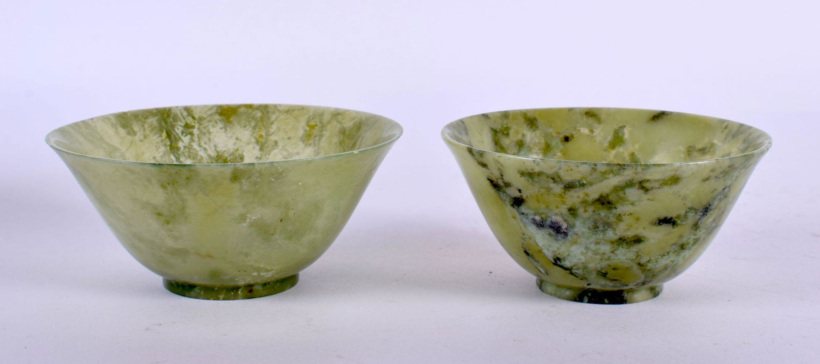 TWO EARLY 20TH CENTURY CHINESE CARVED JADEITE BOWLS Late Qing/Republic. Largest 9.5 cm diameter. (2) (1 of 4)
