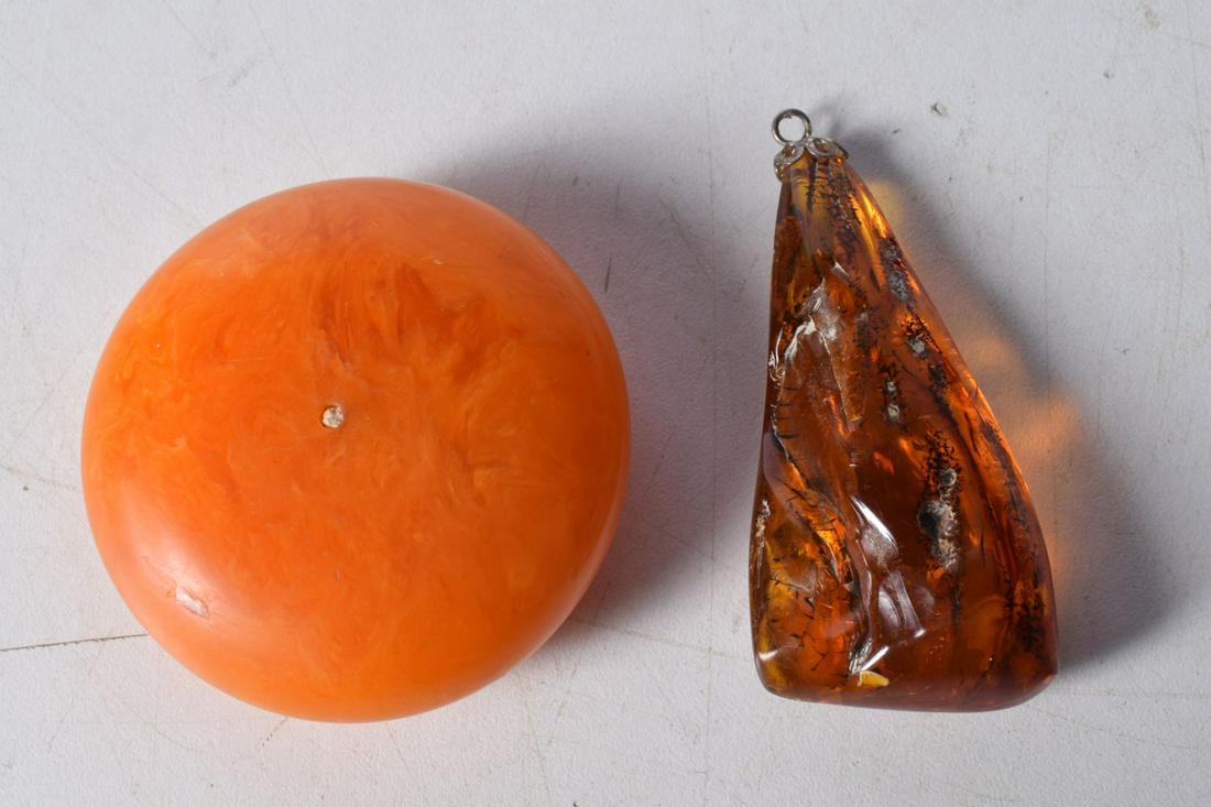 A amber type pendant together with a large resin bead largest 7 cm (2). (1 of 2)