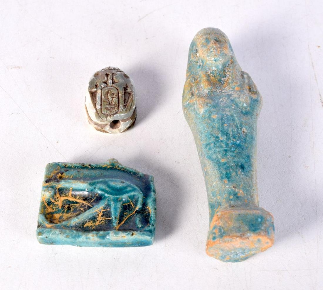 An Egyptian blue glazed pottery shabti, together with two other items. Largest 10.5 cm. (3) (1 of 2)