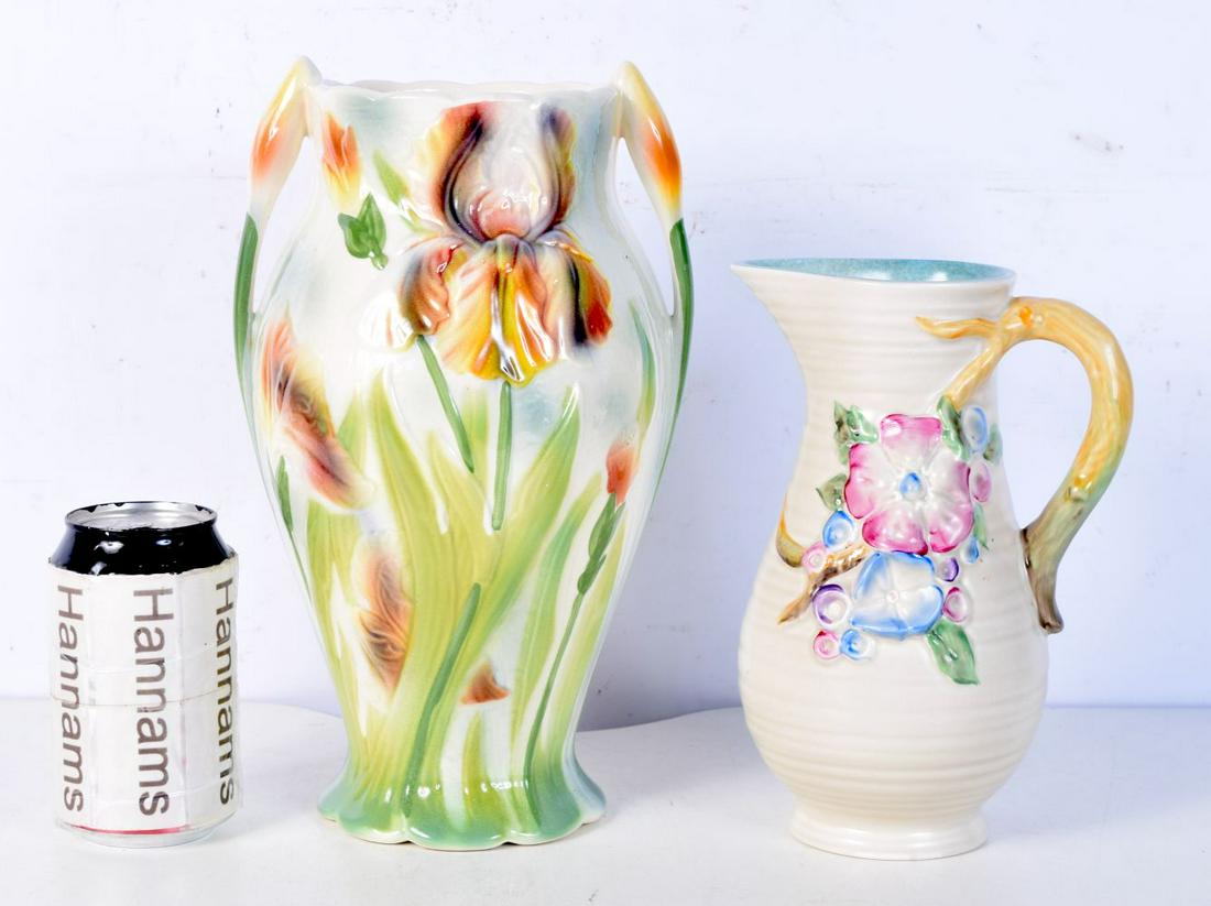 A Large French porcelain St Clement twin handled flower vase together with a Newport pottery jug dec: A Large French porcelain St Clement twin handled flower vase together with a Newport pottery jug decorated with flowers largest 27 cm (2).