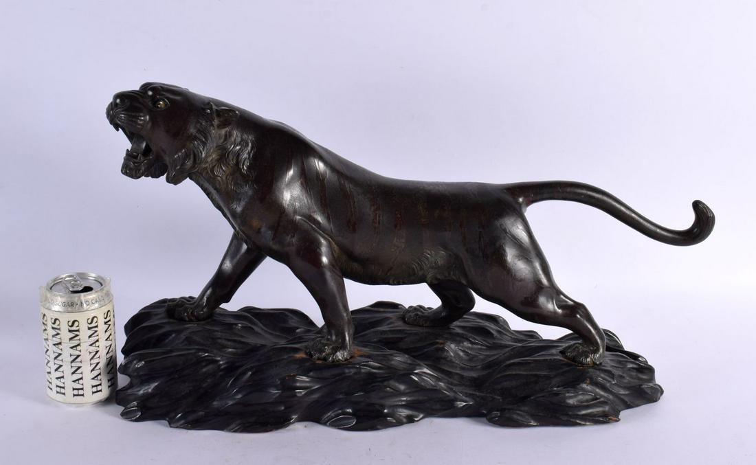 A LARGE 19TH CENTURY JAPANESE MEIJI PERIOD BRONZE OKIMONO modelled as a roaming tiger, with glass ey (1 of 12)