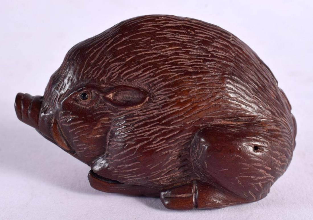 A JAPANESE CARVED WOOD BOAR NETSUKE. 6 cm x 4 cm.: A JAPANESE CARVED WOOD BOAR NETSUKE. 6 cm x 4 cm.