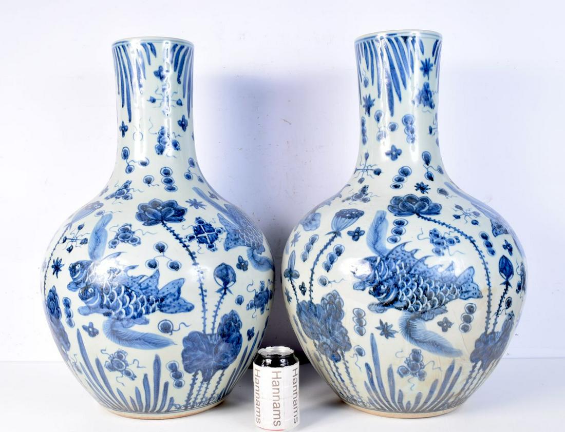 A large pair of blue and white porcelain vases decorated with fish. 59cm (2). (1 of 3)