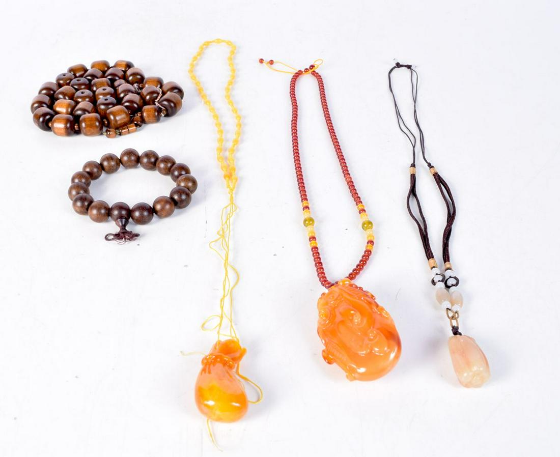 A collection of Chinese necklaces with pendants together with a collection of wooden beads. Largest (1 of 1)