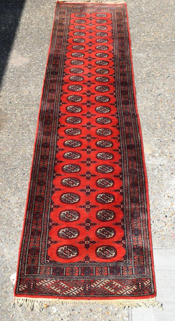 A red ground Bokhara runner 330 x 81 cm. (1 of 5)