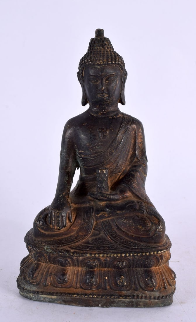 A 19TH CENTURY CHINESE TIBETAN BRONZE FIGURE OF A SEATED BUDDHA modelled upon a triangular base. 14 (1 of 5)