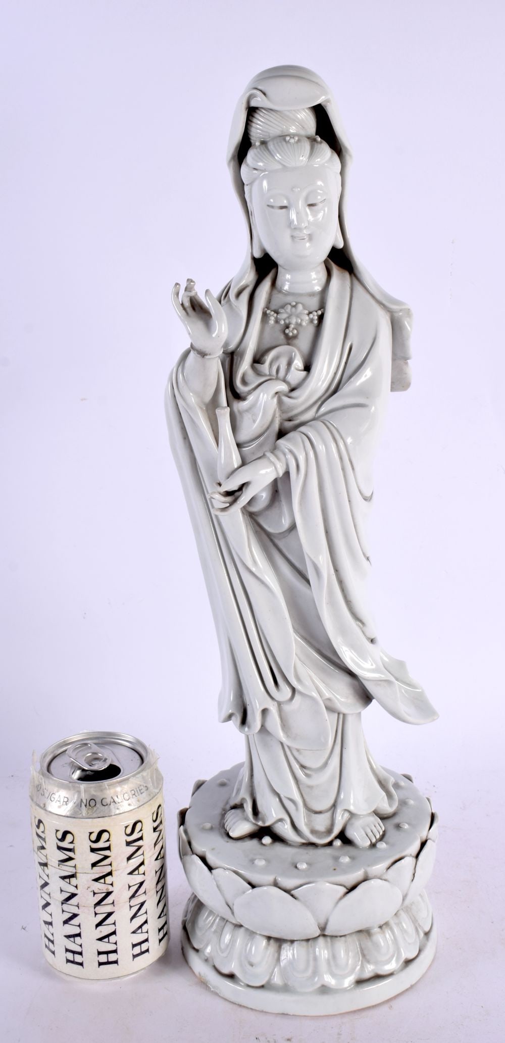 A LARGE CHINESE QING DYNASTY BLANC DE CHINE FIGURE OF AN IMMORTAL modelled upon a lotus capped base.: A LARGE CHINESE QING DYNASTY BLANC DE CHINE FIGURE OF AN IMMORTAL modelled upon a lotus capped base. 44 cm high.