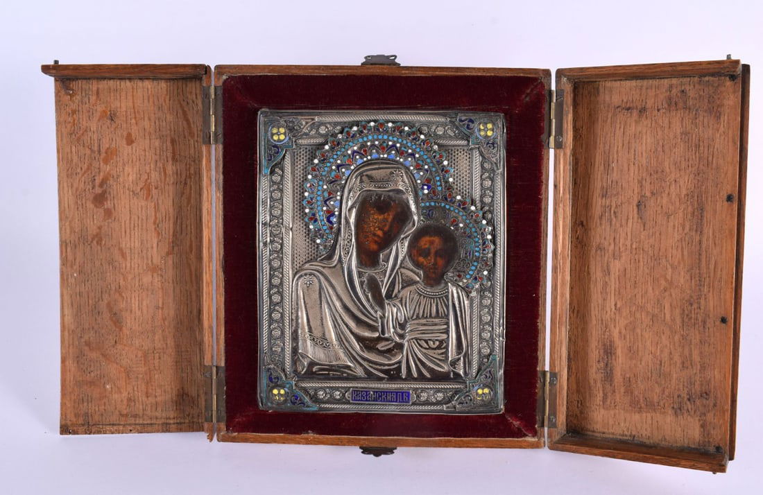 A GOOD 19TH CENTURY CASED RUSSIAN SILVER AND POLYCHROMED WOOD ICON depicting the Madonna and child, (1 of 8)