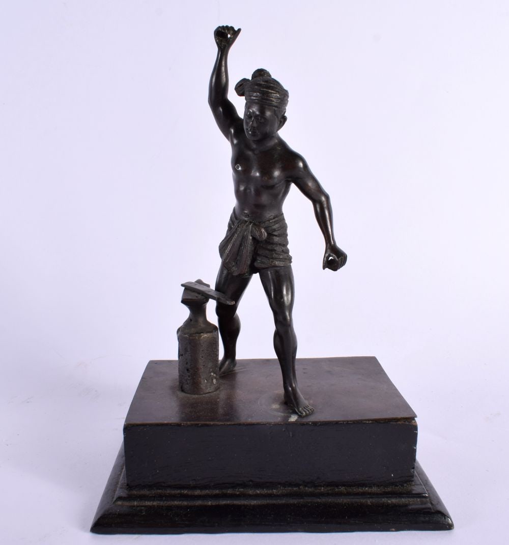 AN ANTIQUE SOUTHEAST ASIAN BRONZE FIGURE OF A MALE modelled beside an anvil. 19 cm x 13 cm. (1 of 5)