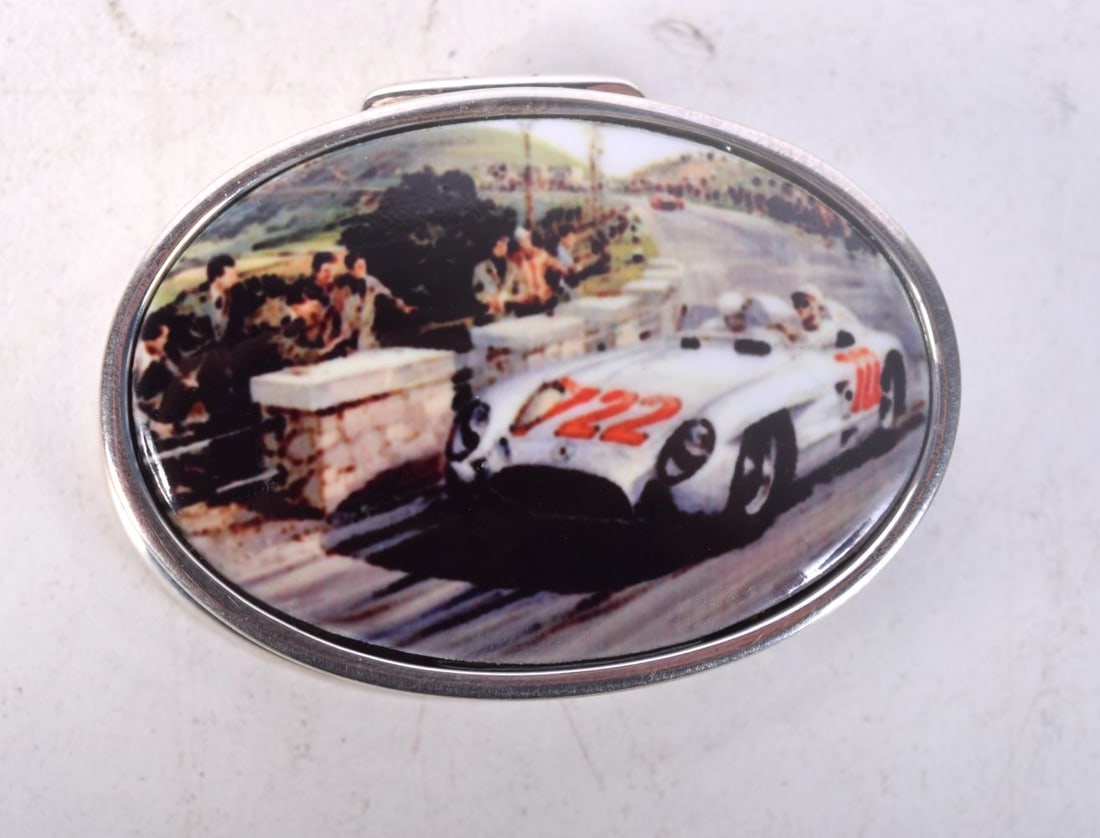 A SILVER AND ENAMEL PILL BOX WITH THE LID DECORATED WITH A MOTOR RACING SCENE. Stamped 925, 3.7cm x: A SILVER AND ENAMEL PILL BOX WITH THE LID DECORATED WITH A MOTOR RACING SCENE. Stamped 925, 3.7cm x 2.8cm x 1.3cm, weight 19.6g
