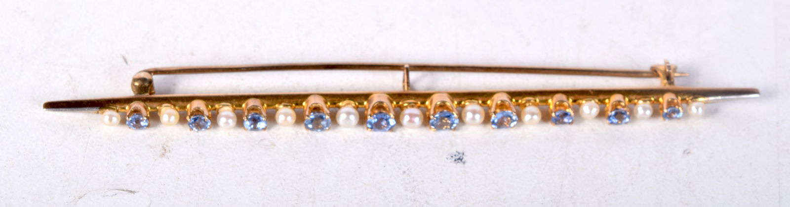A 14CT GOLD BAR BROOCH SET WITH SAPPHIRES AND PEARLS.  Stamped 14K, 8.cm x 0.3cm, weight 4.9g (1 of 2)