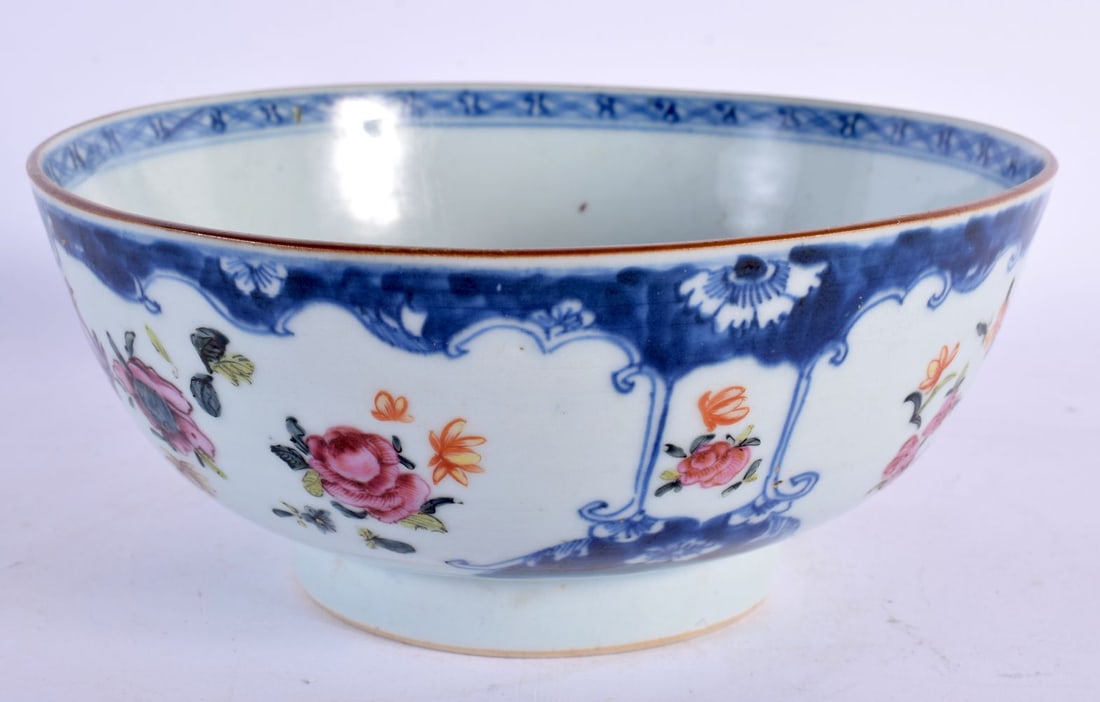 AN 18TH CENTURY CHINESE EXPORT FAMILLE ROSE BLUE AND WHITE PORCELAIN BOWL Qianlong, painted with flo: AN 18TH CENTURY CHINESE EXPORT FAMILLE ROSE BLUE AND WHITE PORCELAIN BOWL Qianlong, painted with flowers. 19 cm diameter.