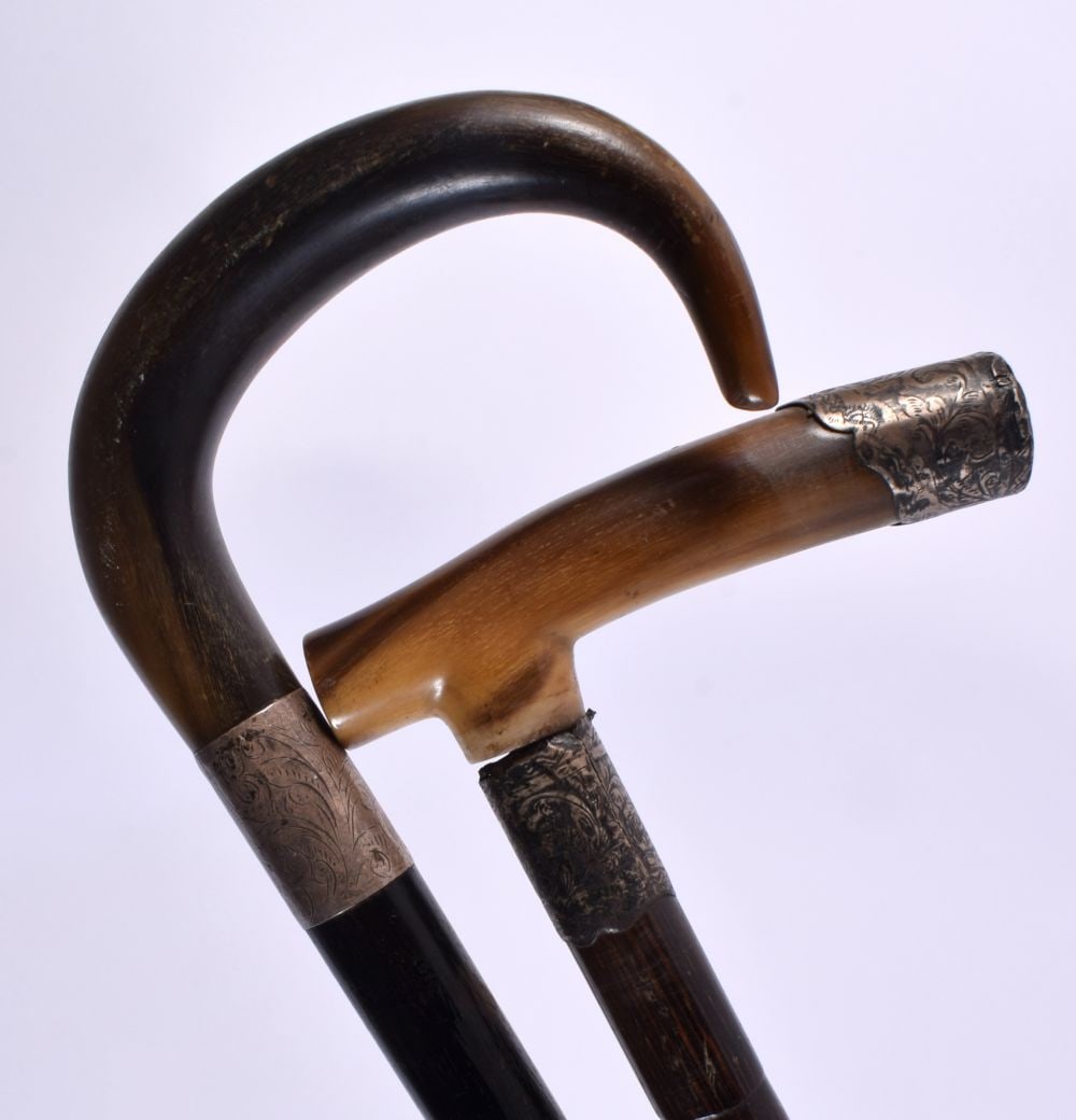 TWO 19TH CENTURY MIDDLE EASTERN CARVED RHINOCEROS HORN WALKING CANES with silver mounts. 90 cm long. (1 of 7)