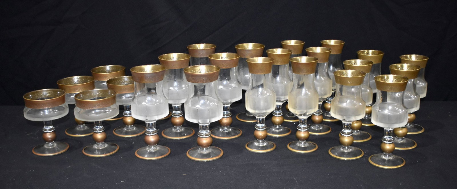 A collection of vintage European glasses, possibly Baccarat or St Louis, with engraved gilt painted: A collection of vintage European glasses, possibly Baccarat or St Louis, with engraved gilt painted rim and a faceted mid section. Tallest 21cm (24).