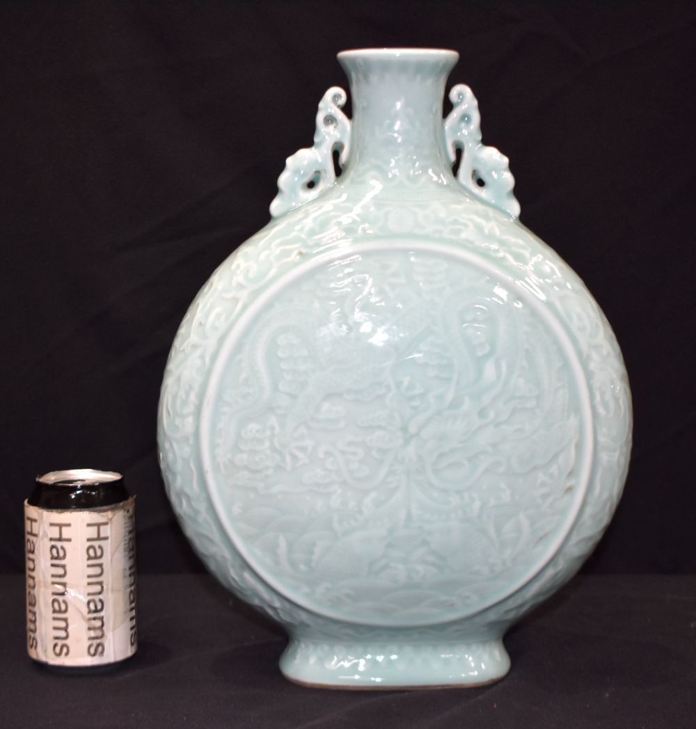 A Chinese porcelain Celadon moonflask decorated with a dragon in relief. 37cm.: A Chinese porcelain Celadon moonflask decorated with a dragon in relief. 37cm.