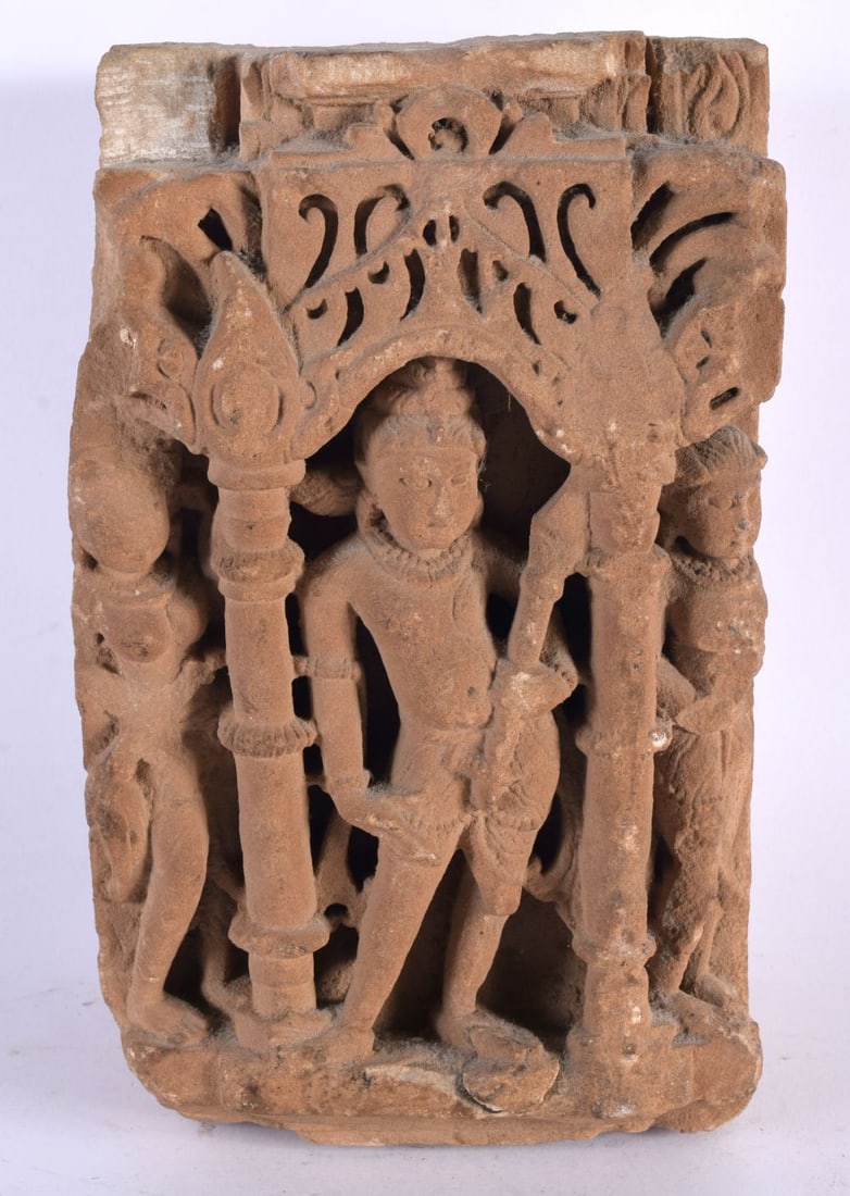 A 10th / 11th Century Buff Sandstone Relief depicting Shiva in Tribhanga in an alcove flanked by pil: A 10th / 11th Century Buff Sandstone Relief depicting Shiva in Tribhanga in an alcove flanked by pillars, two female attendants at the sides, Madhya Pradesh, Central India. 13 cm x 10 cm x 21.5 cm.