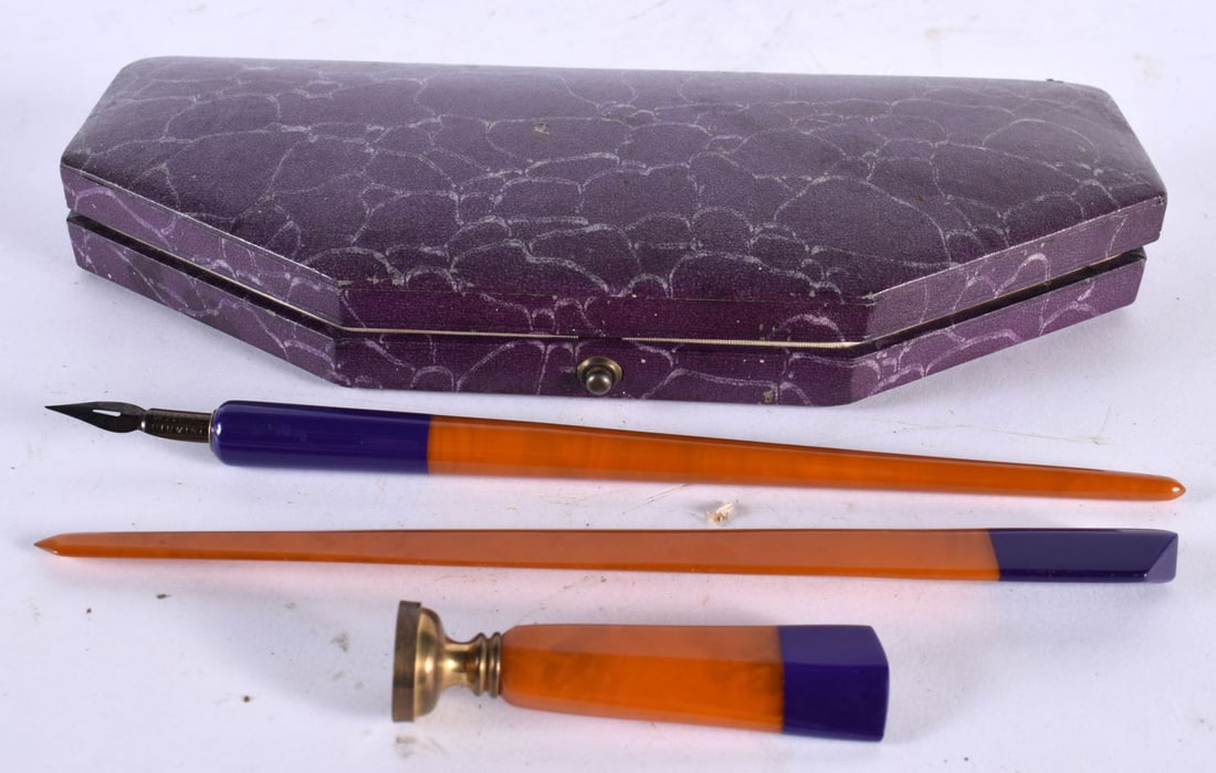 A RARE EARLY 20TH CENTURY TWO TONE CATALIN AMBER BAKELITE DESK SET comprising of pen, letter opener (1 of 3)