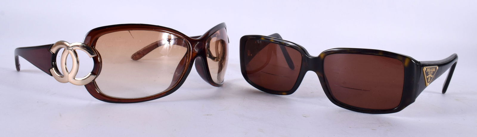 A PAIR OF CHANEL SUNGLASSES and a pair of Prada glasses. (2): A PAIR OF CHANEL SUNGLASSES and a pair of Prada glasses. (2)