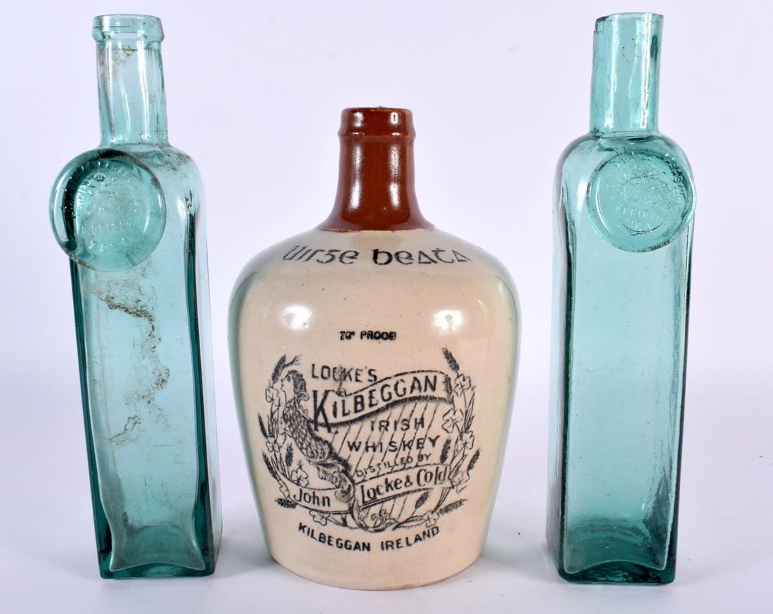 AN IRISH JOHN LOCKES KILBEGGAN WHISKEY JUG together with two Hungarian wine bottles. Largest 22cm hi: AN IRISH JOHN LOCKES KILBEGGAN WHISKEY JUG together with two Hungarian wine bottles. Largest 22cm high. (3)