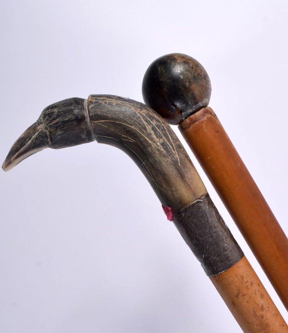 A 19TH CENTURY MIDDLE EASTERN CARVED RHINOCEROS HORN CANE together with another horn handled cane. 9 (1 of 7)
