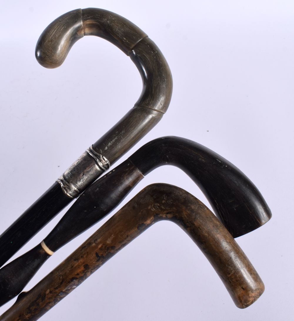 A 19TH CENTURY MIDDLE EASTERN RHINOCEROS HORN CANE together with two others. 90cm long. (3) (1 of 12)